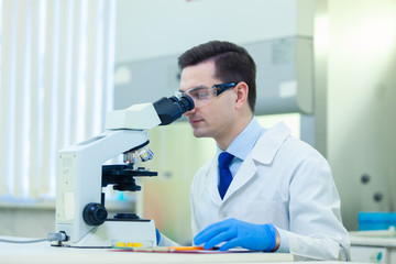  Scientist studies properties and benefits of omega 3 fatty acids using microscope and laboratory equipment in a medical laboratory