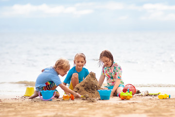 Wall Mural - Kids playing on beach. Children play at sea.