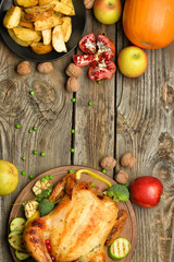 Tasty baked turkey and different food for Thanksgiving day on wooden table