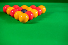 Red And Yellow Pool Balls Set Up In The Triangle Formation On The Green Felt Of An 8 Ball Pool Table