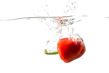 Red Pepper With Spray Of Water Isolated On A White Background.