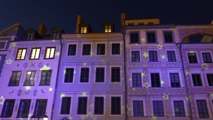 Wall Mural - City of Warsaw in Poland, Old Town houses panning at night, historic tenement buildings with Christmas holiday illumination on facade