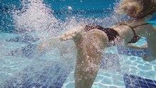 Blonde Hair Girl Jumping Underwater, Shooting From Pool.