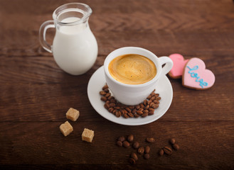 Wall Mural - white cup coffe sugar grains carafe of milk on wooden board