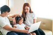 © tuastockphoto - Happy Asian Family doing activity together in living room, Asian Family Concept