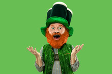 Astonished, Surprised. Excited Leprechaun In Green Suit With Red Beard On Green Background. Funny Portrait Of Man Ready To Party. Saint Patrick Day, Human Emotions, Celebration, Traditional Holidays.