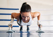 © GVS - Young fit woman doing push ups in gym