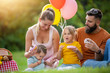 © Sanja_85 - Happy family having picnic in the park
