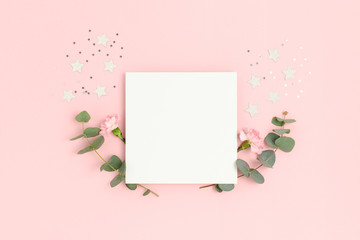 Wall Mural - blank paper card mockup with carnation flowers, eucalyptus and stars confetti. holiday concept with 