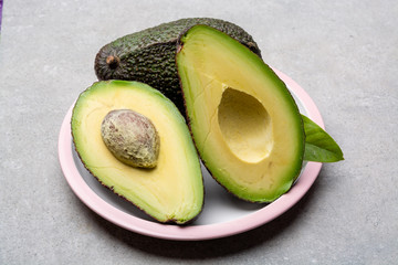 New harvest of fresh ripe hass avocado, cut in half