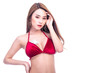 © Sasils Production - Cute asian woman with dollar bill on her chest isolated in white background. Hand on face.