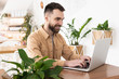 © studioprodakshn - Young handsome man works in his laptop during lunch break at cafe, multitasking concept
