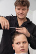 © schankz - Hairdresser cuts the hair of a boy with scissors