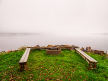 Benches And Firepit By Misty Lake