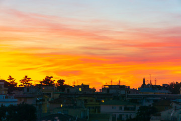 Wall Mural - Sunset landscape on the city. Bright orange and yellow colors sunset sky. Yellow blue sunrise sky with sunlight