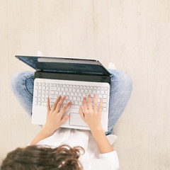 young woman using laptop. Top view girl hands at computer keyboard. Lifestyle network technology. Creative education research. Wireless device.