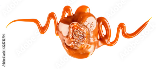 Fotografía Salty Caramel candies with caramel sauce isolated on a white background close up