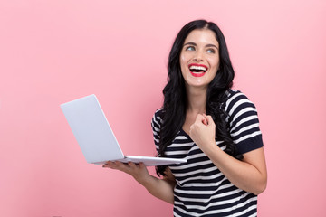 Wall Mural - Young woman with a laptop computer with successful pose