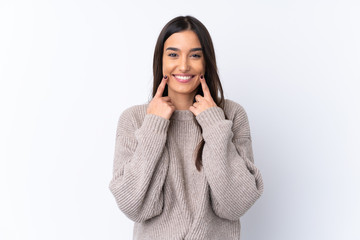Wall Mural - Young brunette woman over isolated white background smiling with a happy and pleasant expression