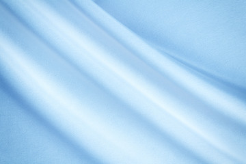 Wall Mural - light blue fabric with diagonal folds, textile background