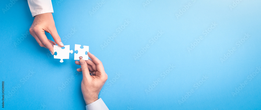 People holds in hand a jigsaw puzzle. Business solutions, success and strategy. - obrazy, fototapety, plakaty 