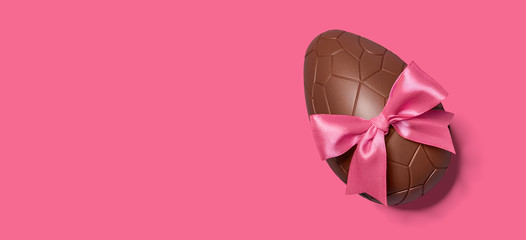 Wall Mural - Chocolate Easter egg with pink ribbon bow