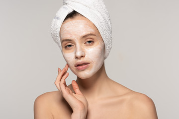 Wall Mural - beautiful young woman with cosmetic mask on face and towel on head, isolated on grey