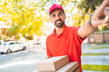Delivery Man Carrying Packages While Making Home Delivery.