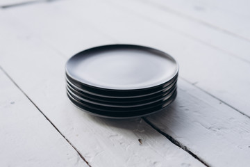 gray plates on a white wooden background