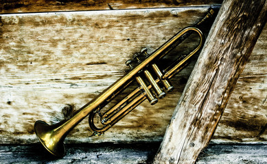 Sticker - an ancient jazz trumpet with wooden background