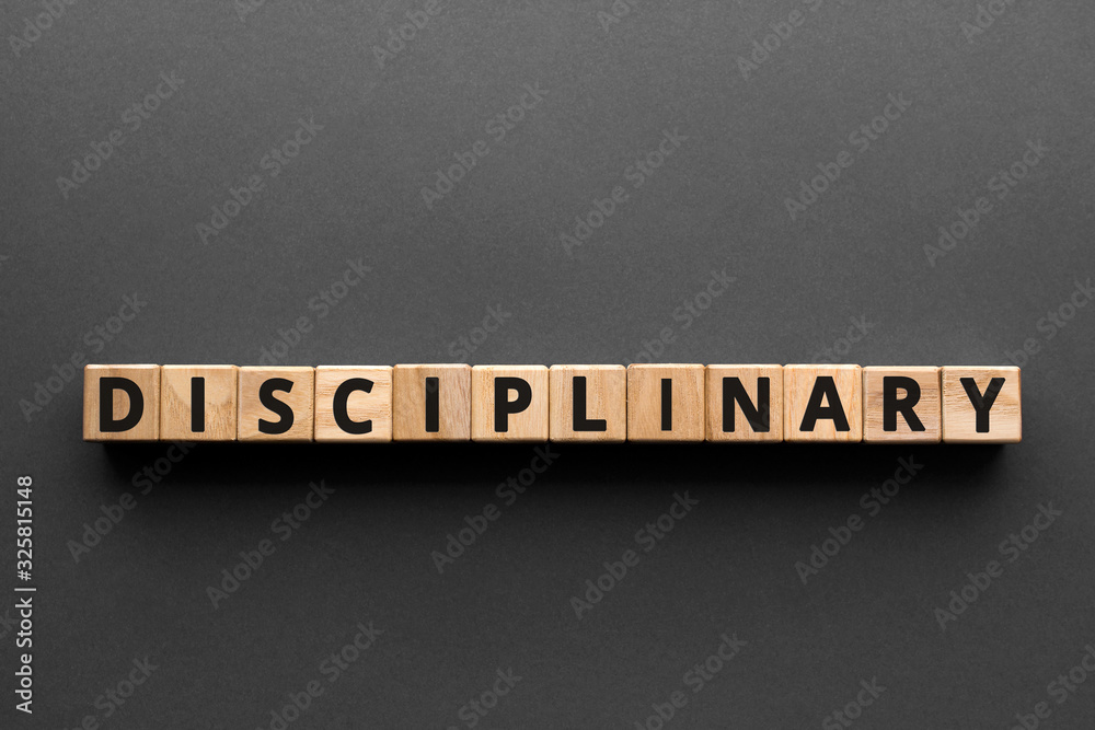 Disciplinary - words from wooden blocks with letters, enforcing ...