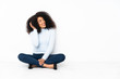 © luismolinero - Young african american woman sitting on the floor thinking an idea