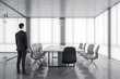 © Who is Danny - Businessman standing contemporary meeting room interior