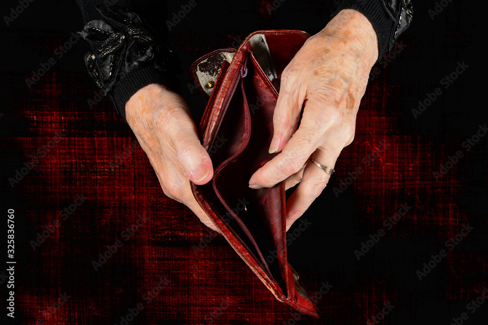Old lady holds empty old shabby wallet in her hands. Concept of lack of ...