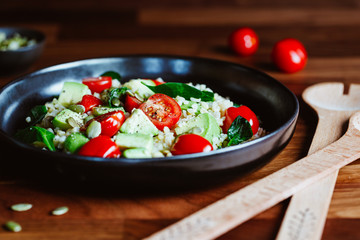 Wall Mural - Healthy salad with bulgur, avocado, spinach and cherry tomatoes.