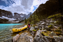 A Woman Prepares For A Rafting Trip Across Cirque Lake In Banff.