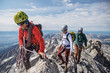 © Cavan Images - Climbing guide leads two clients to the summit of the Grand Teton