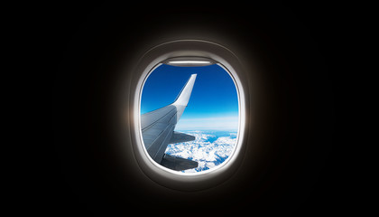 Wall Mural - Black background with copy space with look of window frame of airplane flight see view of sunset clouds, airplane wing, ice mountains for luxury trip tourism travel transportation concept