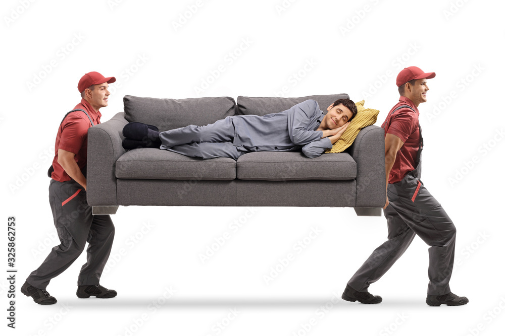 Two movers carrying a couch and a man in pajamas sleeping on it - obrazy, fototapety, plakaty 