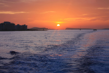 Wall Mural - romantic orange sunset over the water of the sea and the chain or anchor of a boat to the side
