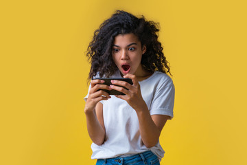 Wall Mural - Portrait of attractive young african american girl using mobile phone