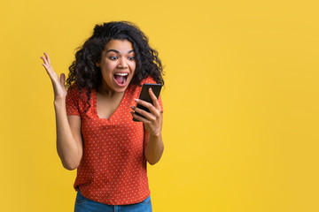 Wall Mural - Portrait of attractive young african american girl using mobile phone