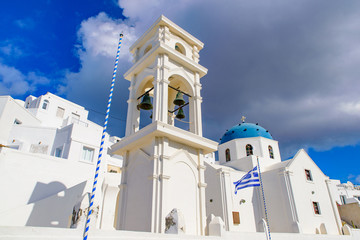 A blue domed church with bell tower in Imerovigli village, Santorini, Greece