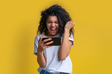 Wall Mural - Portrait of attractive young african american girl using mobile phone