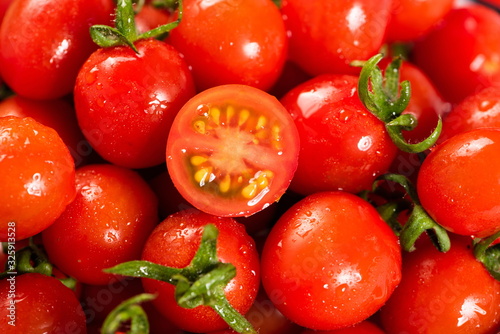 Cuadros en Lienzo The red little tomato is under the wooden cutting board