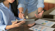 © bongkarn - Cropped shot of two businesspeople briefing on their project on wooden table