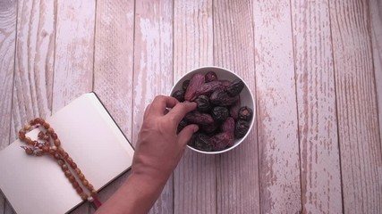 Sticker - top view of date fruit in a bowl, hand pick the date fruit.