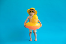 Happy Child With Yellow Rubber Duck Against Blue Background