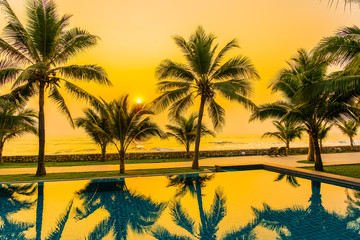 Beautiful nature with palm tree around outdoor swimming pool in hotel resort nearly sea ocean beach