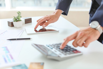 Wall Mural - Male bank manager working in office, closeup